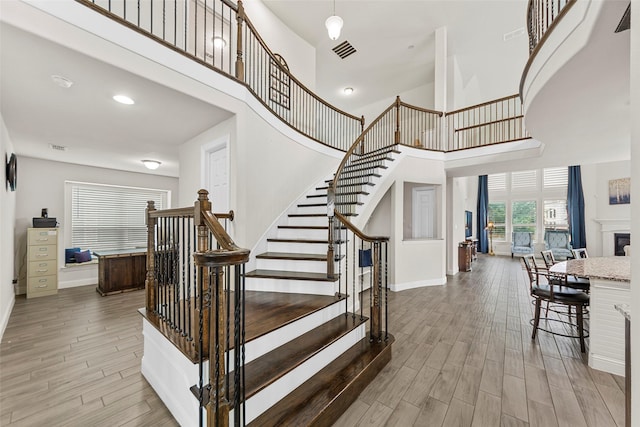 3300 Calvin Rd, Mckinney, TX 75071 - stairs with a high ceiling, wood finished floors, and baseboards