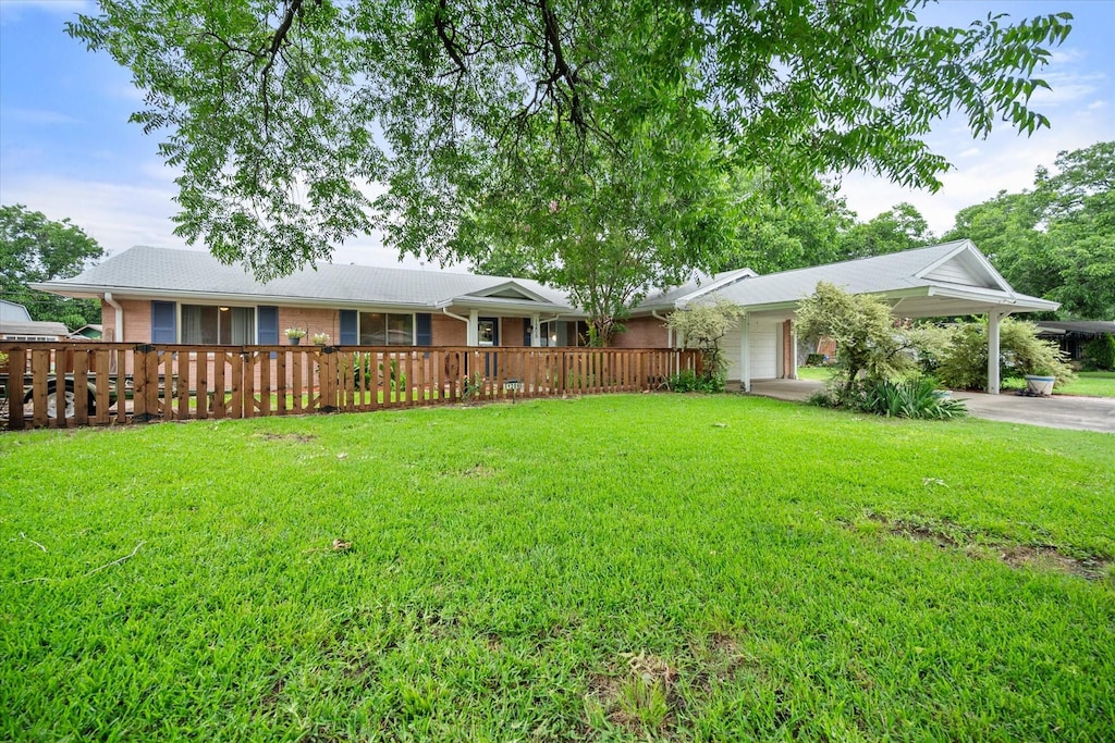 1206 Plattner St, Grand Prairie, TX 75050 - view of green lawn featuring a carport and driveway