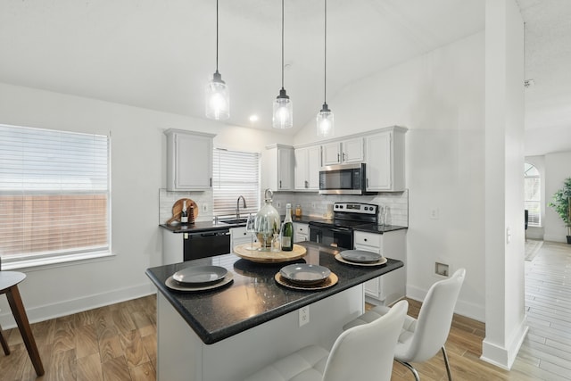 3220 Steamboat Dr, Fort Worth, TX 76123 - kitchen with range with electric stovetop, stainless steel microwave, black dishwasher, dark countertops, and backsplash