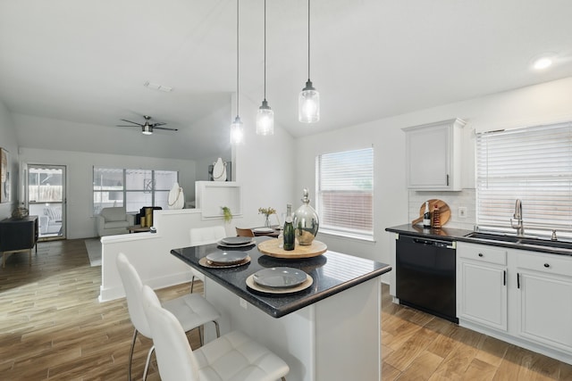 3220 Steamboat Dr, Fort Worth, TX 76123 - kitchen featuring dishwasher, a sink, dark countertops, lofted ceiling, and a kitchen breakfast bar