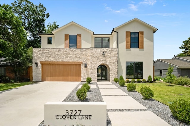 3727 Clover Ln, Dallas, TX 75220 - modern home with stucco siding, a front yard, stone siding, driveway, and an attached garage