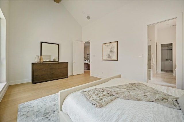3727 Clover Ln, Dallas, TX 75220 - bedroom featuring light wood-type flooring, high vaulted ceiling, and arched walkways
