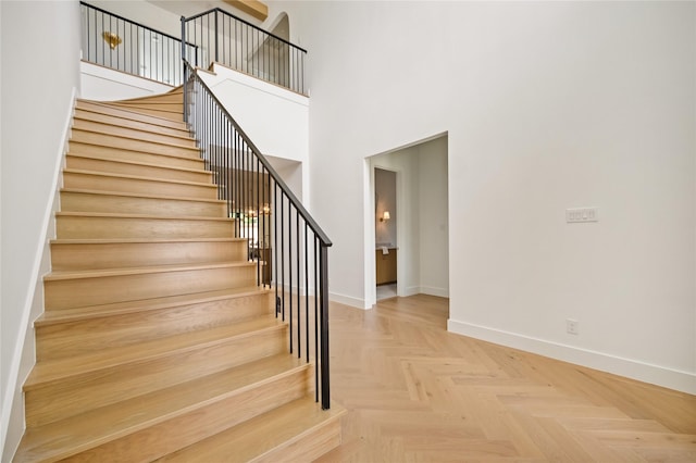 3727 Clover Ln, Dallas, TX 75220 - stairway featuring baseboards and a towering ceiling