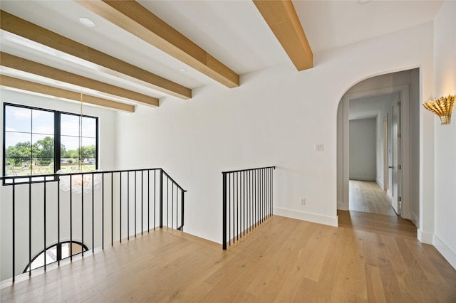 3727 Clover Ln, Dallas, TX 75220 - empty room featuring beam ceiling, wood finished floors, and arched walkways