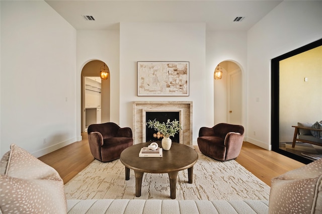 3727 Clover Ln, Dallas, TX 75220 - living room featuring arched walkways, wood finished floors, and a fireplace