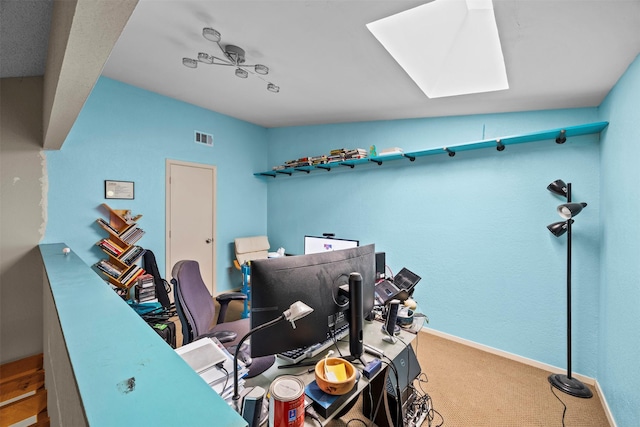 907 Green Terrace Ln, Duncanville, TX 75137 - carpeted home office featuring a skylight and baseboards
