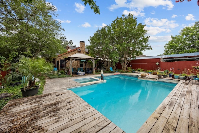 907 Green Terrace Ln, Duncanville, TX 75137 - view of swimming pool with a gazebo, a wooden deck, a pool with connected hot tub, and a fenced backyard