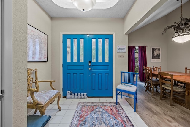 907 Green Terrace Ln, Duncanville, TX 75137 - foyer entrance with tile patterned floors, healthy amount of natural light, and a textured wall