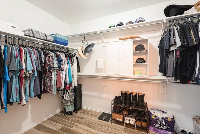 102 Avery Ln, Fate, TX 75189 - walk in closet featuring wood finished floors