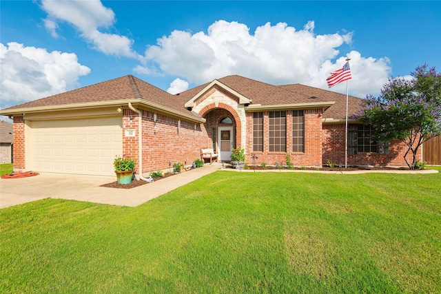 102 Avery Ln, Fate, TX 75189 - view of front of property with concrete driveway, a front lawn, a garage, brick siding, and a shingled roof