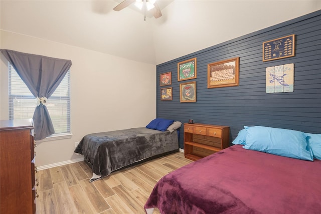 102 Avery Ln, Fate, TX 75189 - bedroom featuring wood finished floors, baseboards, an accent wall, a ceiling fan, and vaulted ceiling