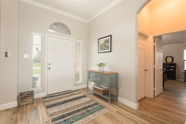 102 Avery Ln, Fate, TX 75189 - foyer with crown molding, baseboards, wood finished floors, and arched walkways