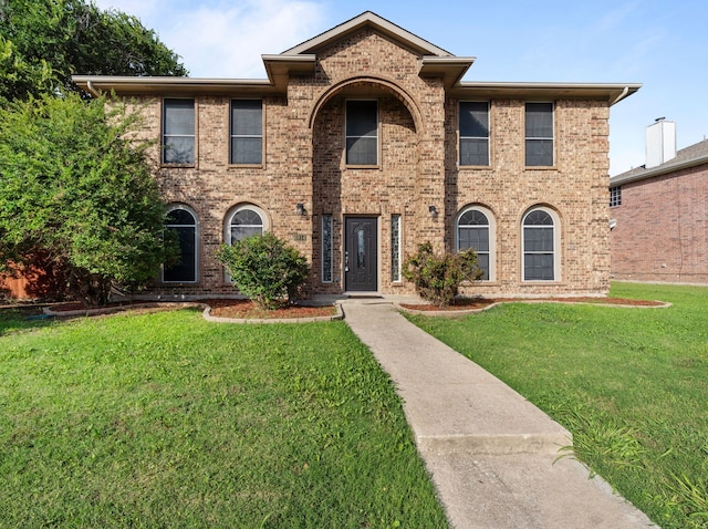 6814 Silver Lake Dr, Rowlett, TX 75089 - view of front facade featuring a front lawn and brick siding