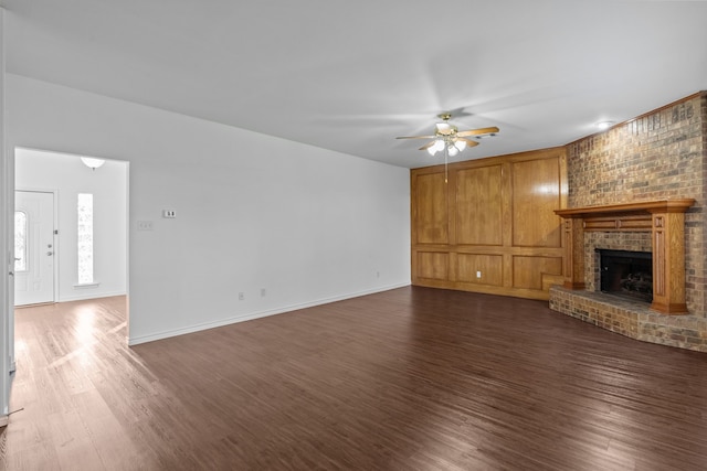 6814 Silver Lake Dr, Rowlett, TX 75089 - unfurnished living room featuring dark wood-style floors, a ceiling fan, a brick fireplace, and baseboards