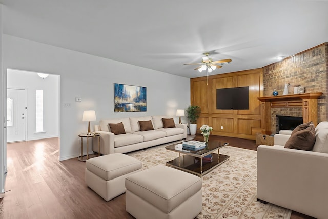 6814 Silver Lake Dr, Rowlett, TX 75089 - living area with a ceiling fan, wood finished floors, a brick fireplace, and baseboards