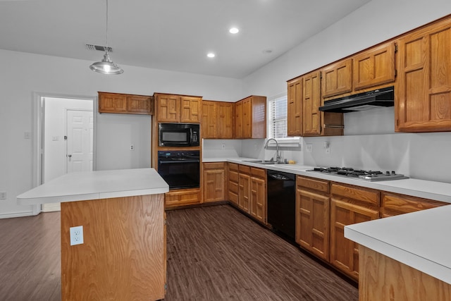 6814 Silver Lake Dr, Rowlett, TX 75089 - kitchen featuring black appliances, a sink, under cabinet range hood, brown cabinetry, and recessed lighting