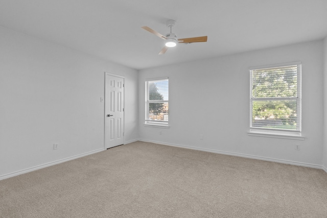6814 Silver Lake Dr, Rowlett, TX 75089 - spare room with light carpet, ceiling fan, and baseboards
