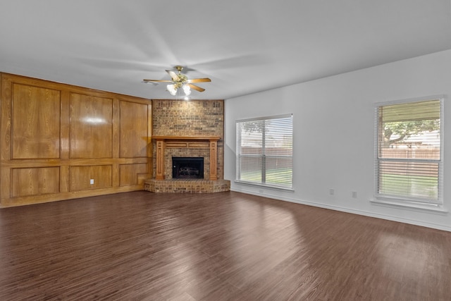 6814 Silver Lake Dr, Rowlett, TX 75089 - unfurnished living room with a ceiling fan, dark wood-style flooring, and a brick fireplace