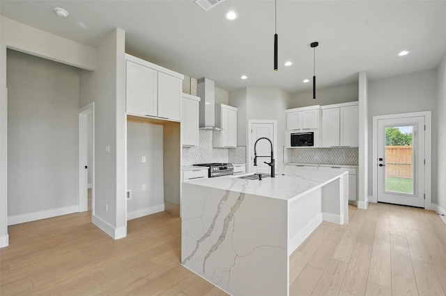 1901 Varsity Dr, Grand Prairie, TX 75051 - kitchen with black microwave, gas stove, wall chimney range hood, tasteful backsplash, and a sink