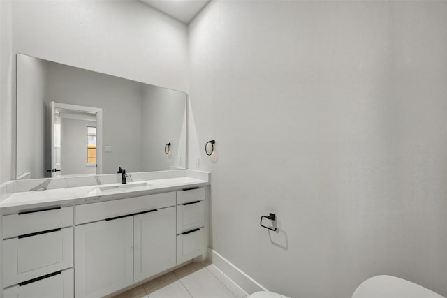 1901 Varsity Dr, Grand Prairie, TX 75051 - bathroom with toilet, vanity, tile patterned floors, and baseboards