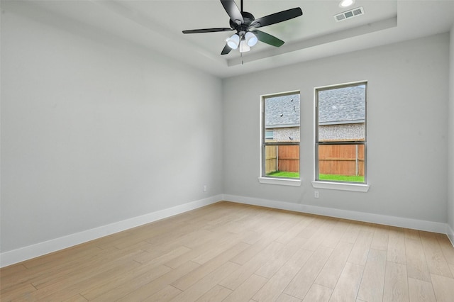 1901 Varsity Dr, Grand Prairie, TX 75051 - unfurnished room with baseboards, light wood-type flooring, a tray ceiling, and ceiling fan