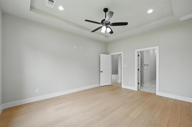 1901 Varsity Dr, Grand Prairie, TX 75051 - unfurnished bedroom featuring light wood-style floors, a raised ceiling, baseboards, and recessed lighting