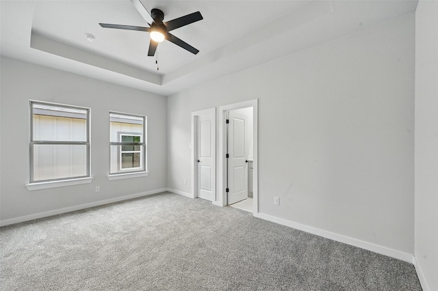 1901 Varsity Dr, Grand Prairie, TX 75051 - unfurnished bedroom featuring carpet, baseboards, a tray ceiling, and ceiling fan