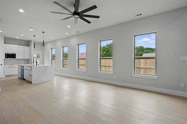 1901 Varsity Dr, Grand Prairie, TX 75051 - unfurnished living room with a ceiling fan, baseboards, a sink, recessed lighting, and light wood-style floors