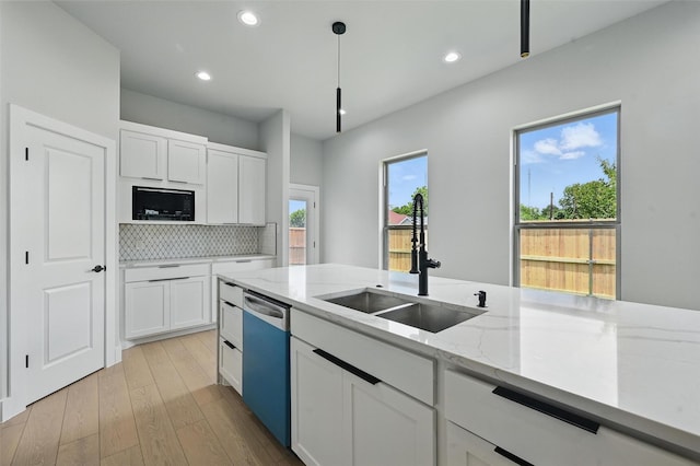 1901 Varsity Dr, Grand Prairie, TX 75051 - kitchen with dishwashing machine, a sink, backsplash, white cabinets, and recessed lighting