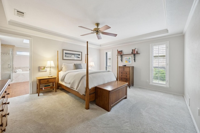 1533 Aylesbury Ln, Plano, TX 75075 - carpeted bedroom featuring a raised ceiling, crown molding, ceiling fan, connected bathroom, and baseboards