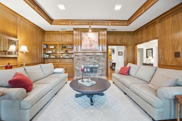 1533 Aylesbury Ln, Plano, TX 75075 - living room featuring a brick fireplace, crown molding, wood walls, and a tray ceiling