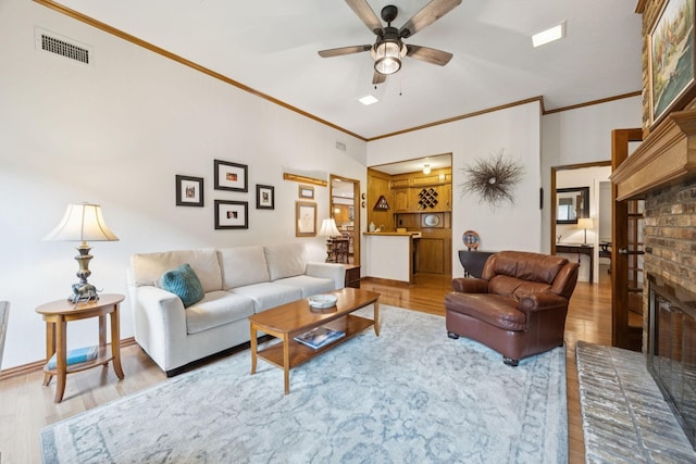 1533 Aylesbury Ln, Plano, TX 75075 - living area with wood finished floors, a fireplace, ceiling fan, and crown molding