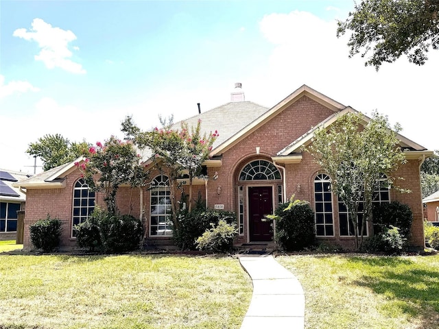 6408 Townsend Ln, Plano, TX 75024 - traditional-style house with brick siding, a front lawn, and a chimney