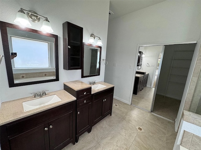6408 Townsend Ln, Plano, TX 75024 - full bath with two vanities, tile patterned flooring, and baseboards