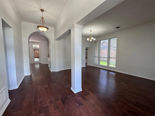 6408 Townsend Ln, Plano, TX 75024 - foyer with ornamental molding, arched walkways, dark wood finished floors, a chandelier, and decorative columns
