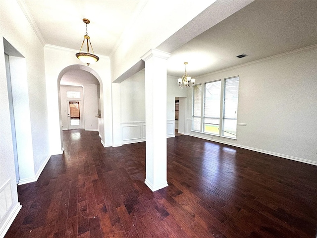 6408 Townsend Ln, Plano, TX 75024 - foyer entrance with crown molding, a chandelier, dark wood-style flooring, ornate columns, and arched walkways