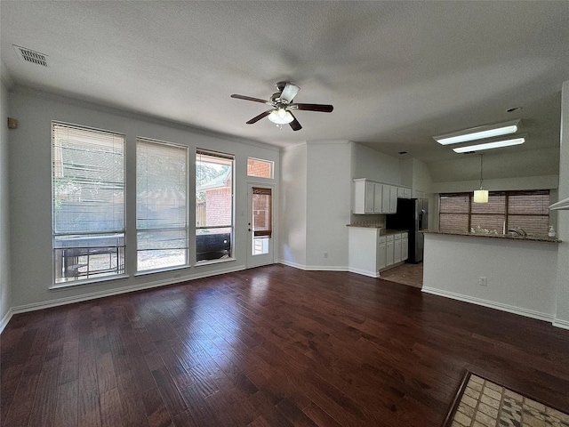 6408 Townsend Ln, Plano, TX 75024 - unfurnished living room with baseboards, dark wood finished floors, ceiling fan, and a textured ceiling