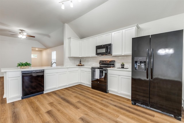 2704 Calmwater Dr, Little Elm, TX 75068 - kitchen featuring black appliances, lofted ceiling, a sink, light countertops, and white cabinets