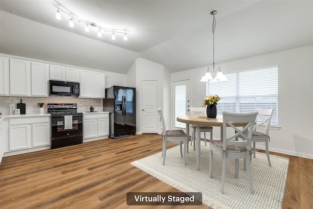 2704 Calmwater Dr, Little Elm, TX 75068 - kitchen featuring black appliances, vaulted ceiling, decorative backsplash, a chandelier, and white cabinets