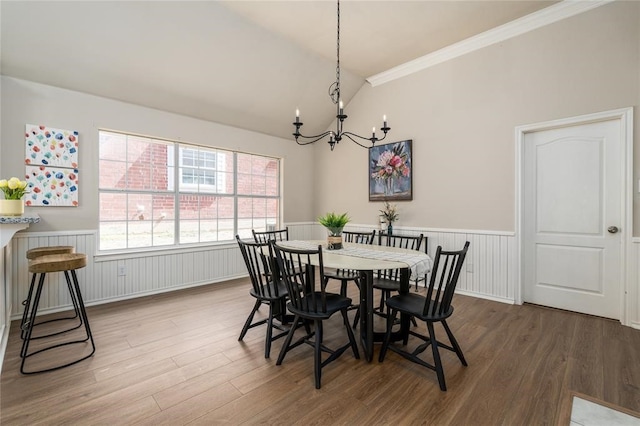 7816 Blossom Dr, Fort Worth, TX 76133 - dining space featuring vaulted ceiling, a chandelier, a wainscoted wall, wood finished floors, and ornamental molding