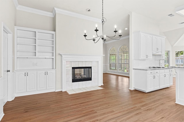 7816 Blossom Dr, Fort Worth, TX 76133 - unfurnished living room with crown molding, a chandelier, light wood-type flooring, and healthy amount of natural light