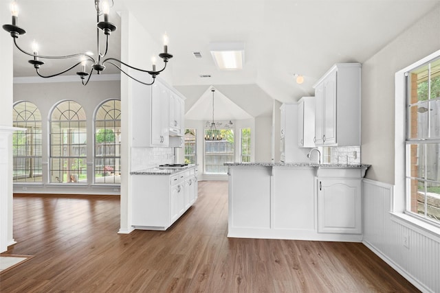 7816 Blossom Dr, Fort Worth, TX 76133 - kitchen with a chandelier, white cabinets, a peninsula, and vaulted ceiling
