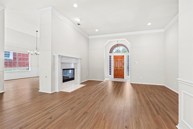 7816 Blossom Dr, Fort Worth, TX 76133 - unfurnished living room featuring a chandelier, healthy amount of natural light, wood finished floors, and ornamental molding
