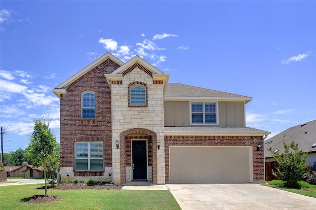 2612 Dancing Flame Dr, Denton, TX 76201 - view of front of home featuring board and batten siding, a garage, concrete driveway, brick siding, and stone siding