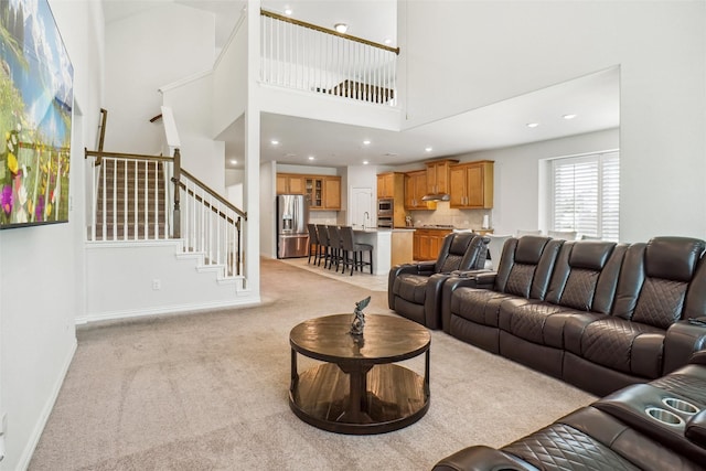 2612 Dancing Flame Dr, Denton, TX 76201 - living room featuring light carpet, stairway, a high ceiling, baseboards, and recessed lighting