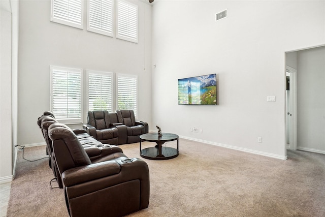 2612 Dancing Flame Dr, Denton, TX 76201 - living area with a towering ceiling, light carpet, and baseboards