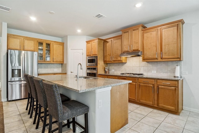 2612 Dancing Flame Dr, Denton, TX 76201 - kitchen featuring appliances with stainless steel finishes, a sink, light tile patterned flooring, decorative backsplash, and recessed lighting