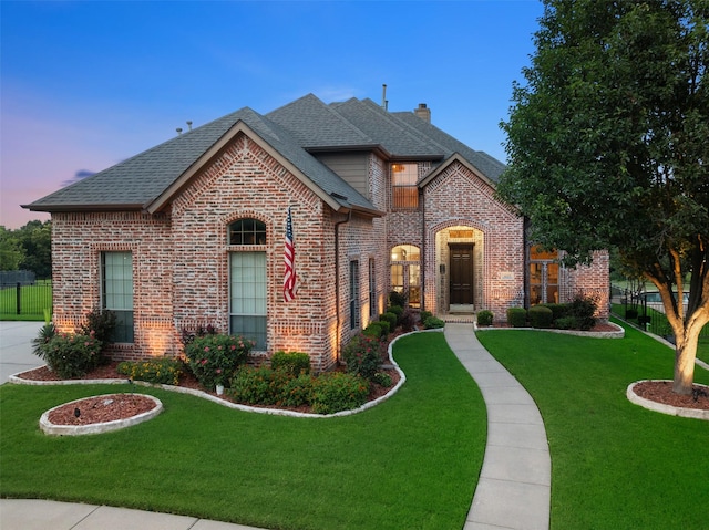 6619 Crestmoor Ln, Sachse, TX 75048 - french country style house featuring brick siding, roof with shingles, and a chimney