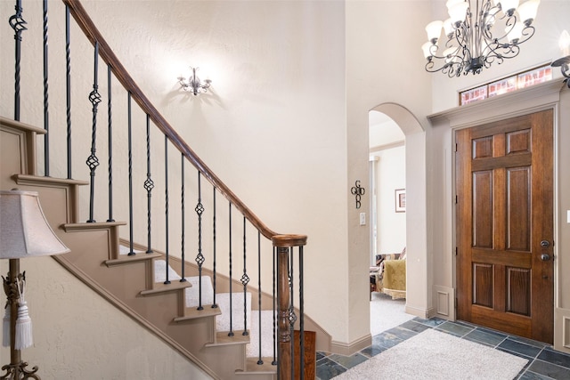 6619 Crestmoor Ln, Sachse, TX 75048 - foyer featuring arched walkways, a chandelier, a high ceiling, and stairway