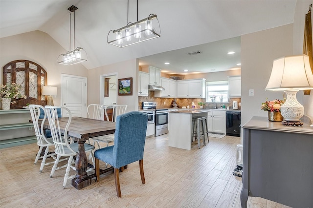 112 Tigers Eye Ct, Weatherford, TX 76087 - dining space featuring light wood finished floors, vaulted ceiling, and a chandelier